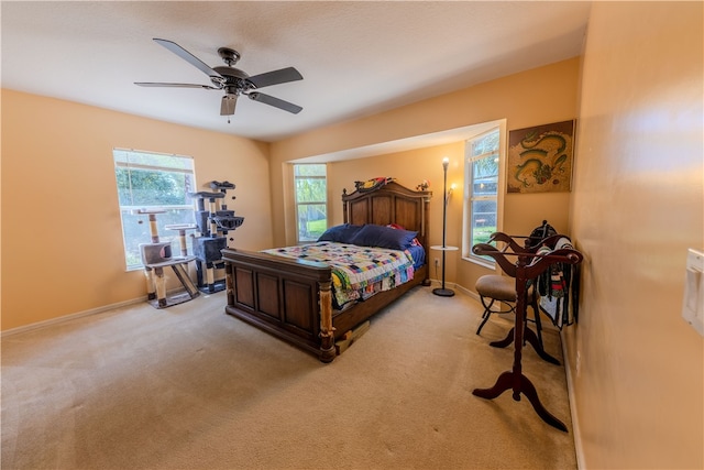 bedroom with ceiling fan and light carpet