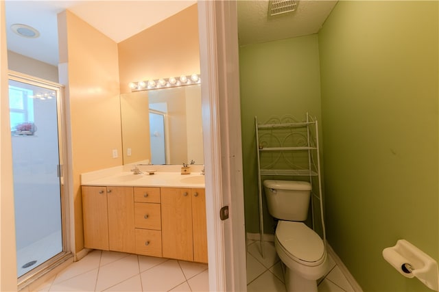 bathroom with vanity, tile patterned flooring, toilet, and lofted ceiling