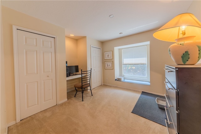 carpeted office with built in desk