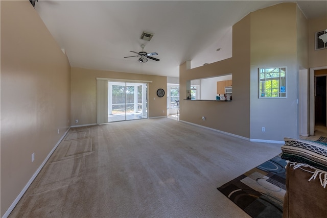 living room featuring light colored carpet, ceiling fan, and plenty of natural light