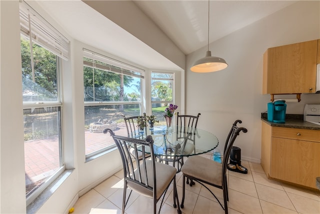 tiled dining area with a wealth of natural light and vaulted ceiling