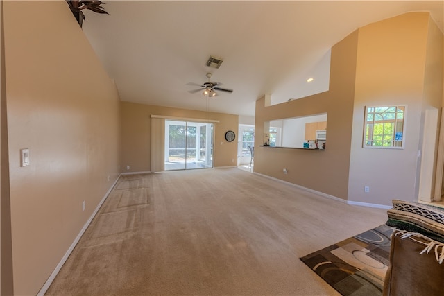 unfurnished living room with ceiling fan, high vaulted ceiling, and carpet