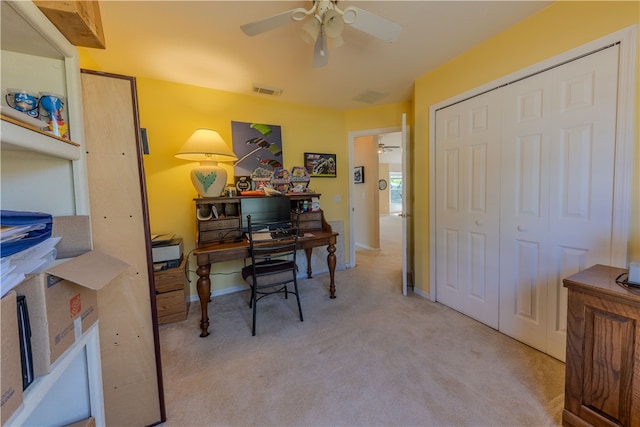 carpeted office space with ceiling fan