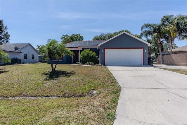 single story home with a garage, solar panels, and a front lawn