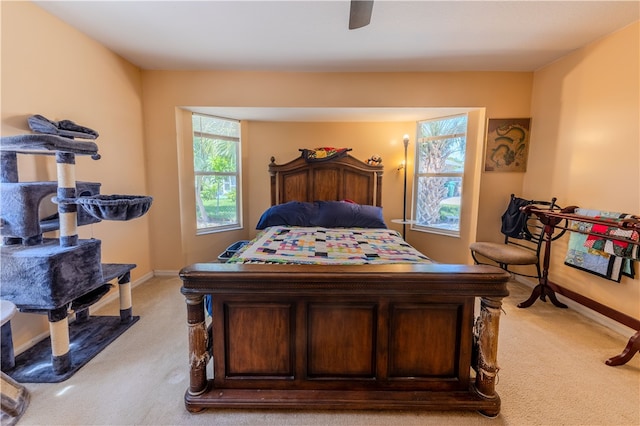 bedroom featuring light colored carpet and ceiling fan