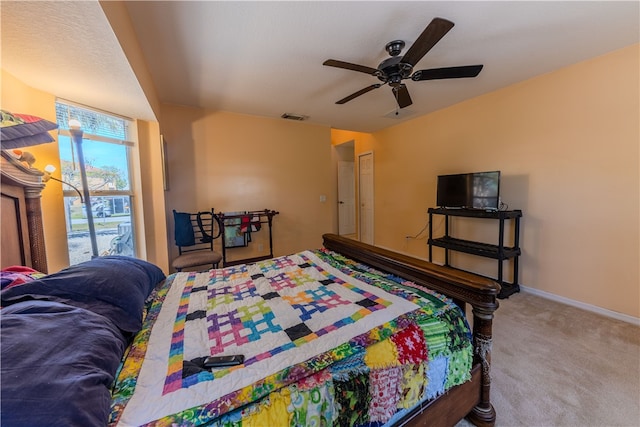 carpeted bedroom featuring ceiling fan and access to exterior