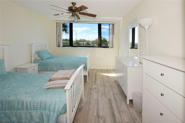 bedroom featuring light wood-type flooring and ceiling fan