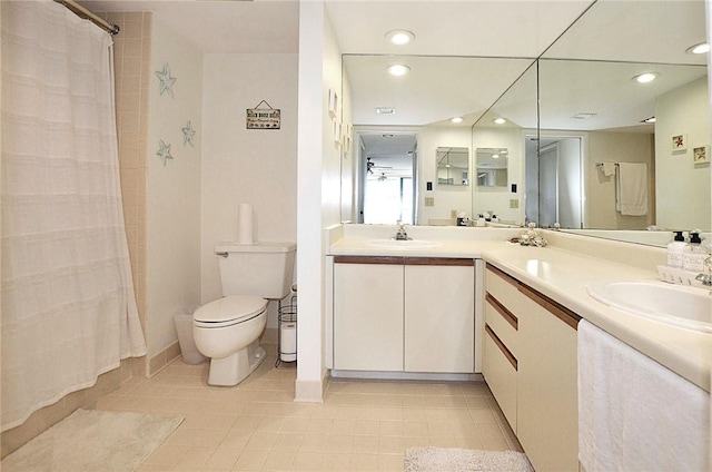 bathroom with a shower with curtain, vanity, ceiling fan, and toilet