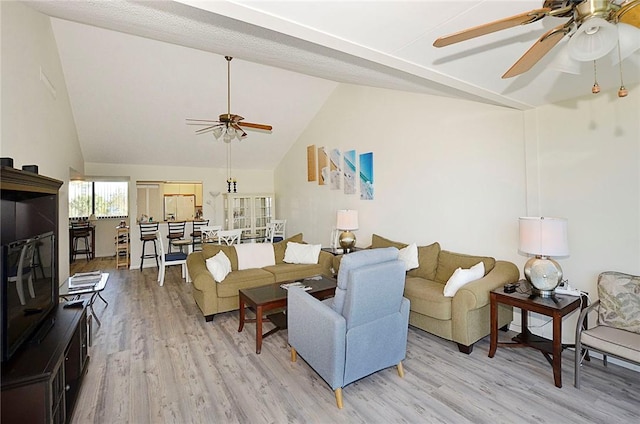 living room featuring vaulted ceiling and light hardwood / wood-style flooring