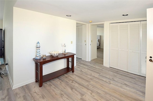 corridor with light hardwood / wood-style floors