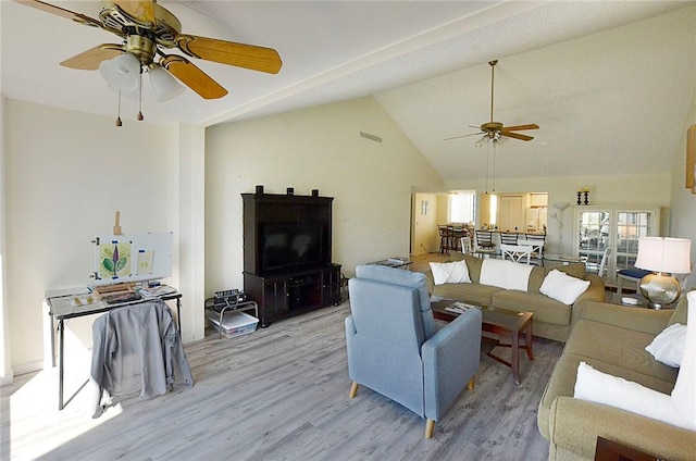 living room featuring light hardwood / wood-style flooring and high vaulted ceiling