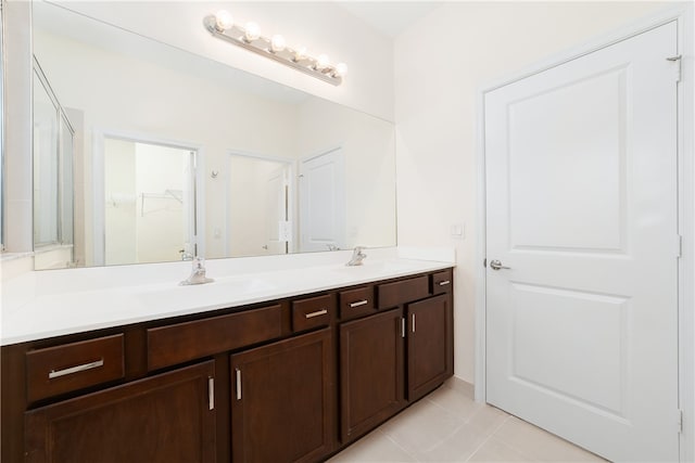 bathroom with tile patterned flooring, an enclosed shower, and vanity