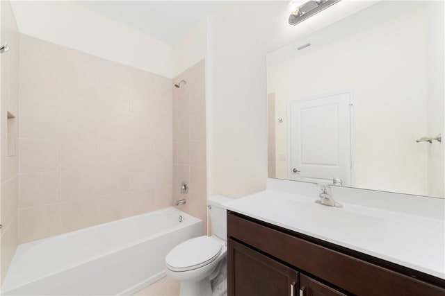 full bathroom with tiled shower / bath, toilet, and vanity