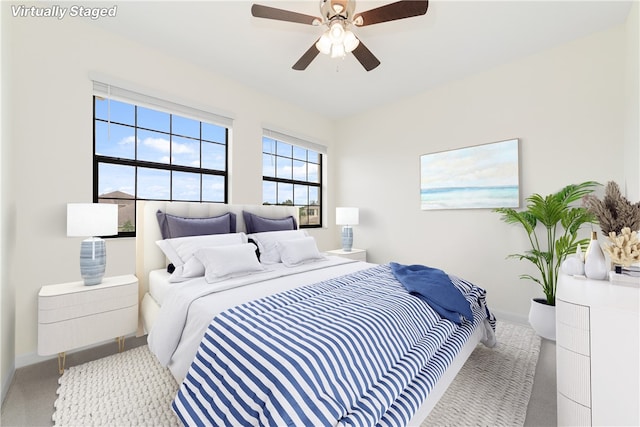 bedroom featuring light carpet and ceiling fan