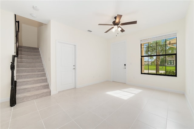 empty room featuring ceiling fan and light tile patterned floors