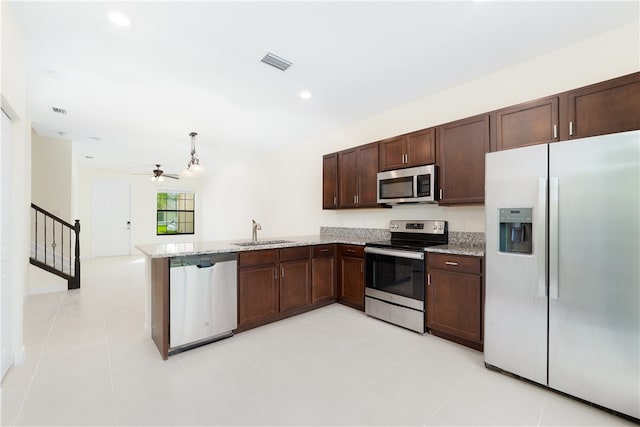 kitchen with sink, kitchen peninsula, appliances with stainless steel finishes, ceiling fan, and light tile patterned floors