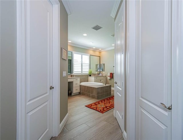 4836 Four Lakes Cir SW, Vero Beach, FL 32968 - full bath with wood finished floors, vanity, crown molding, and a bath