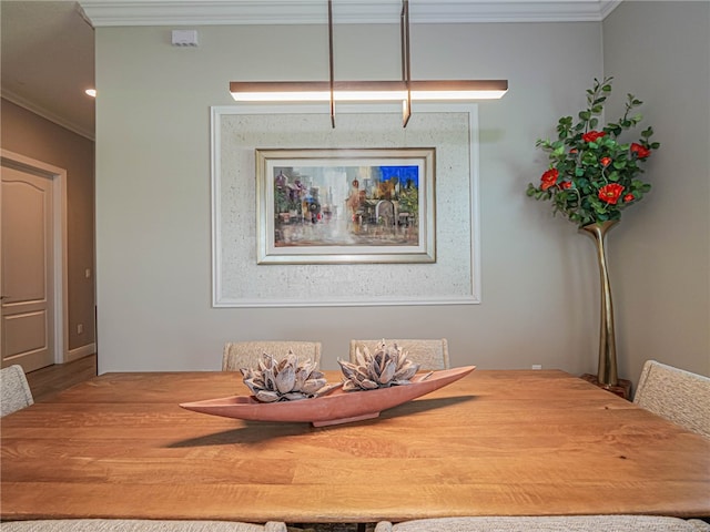 dining area featuring hardwood / wood-style floors and crown molding