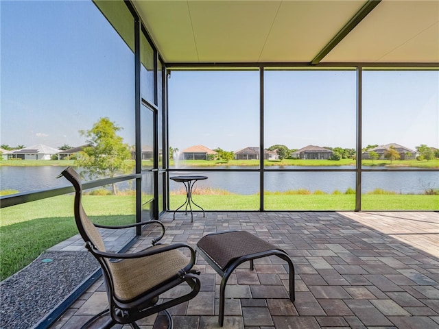 sunroom with a water view and a healthy amount of sunlight