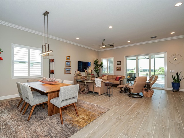 dining area with ceiling fan, light hardwood / wood-style floors, and crown molding