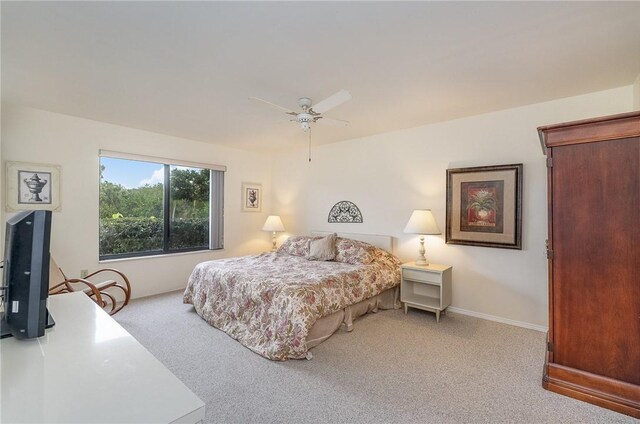 bedroom featuring light colored carpet and ceiling fan