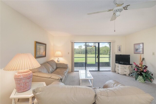 carpeted living room featuring ceiling fan