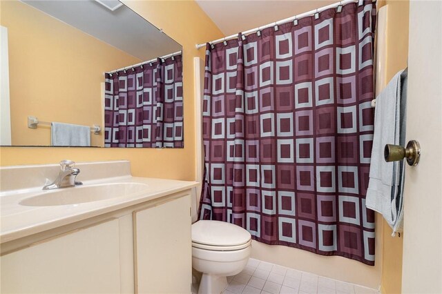 bathroom with tile patterned flooring, vanity, and toilet