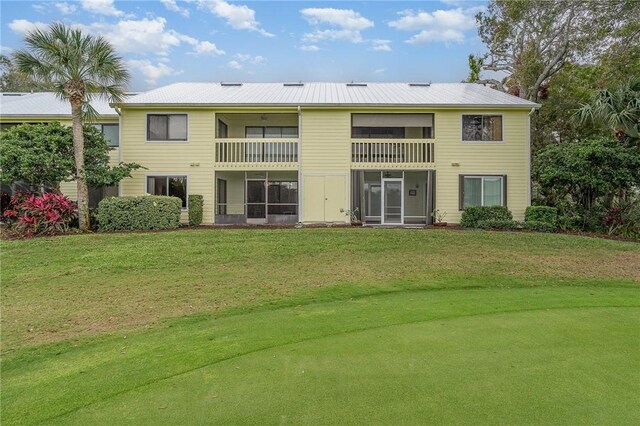 exterior space featuring a balcony and a yard