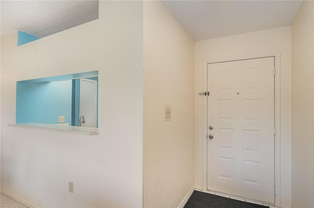 interior space with carpet flooring and a textured ceiling