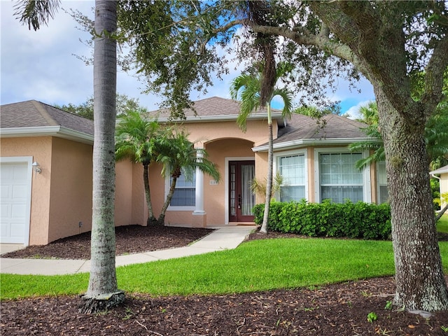 view of front of house with a garage and a front yard