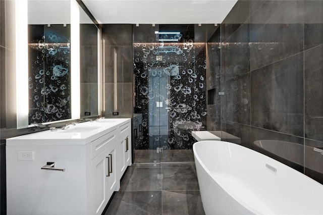 bathroom featuring separate shower and tub, vanity, and tile walls