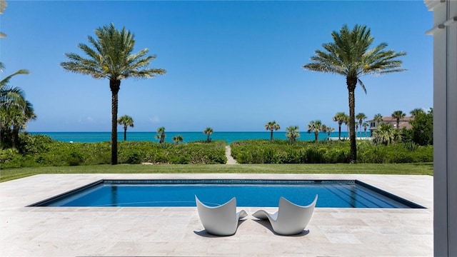 view of swimming pool with a water view