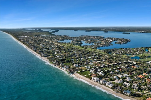 drone / aerial view featuring a view of the beach and a water view