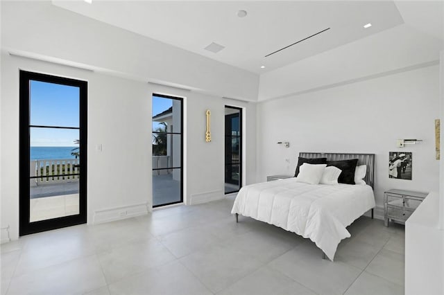 bedroom with access to outside and a water view