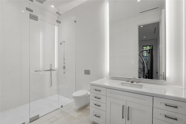 bathroom with vanity, toilet, and a shower with shower door