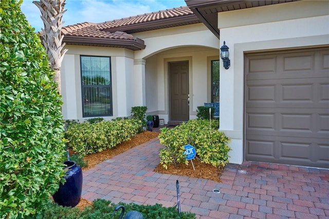 doorway to property with a garage