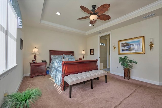 bedroom featuring a raised ceiling, crown molding, light colored carpet, and ceiling fan