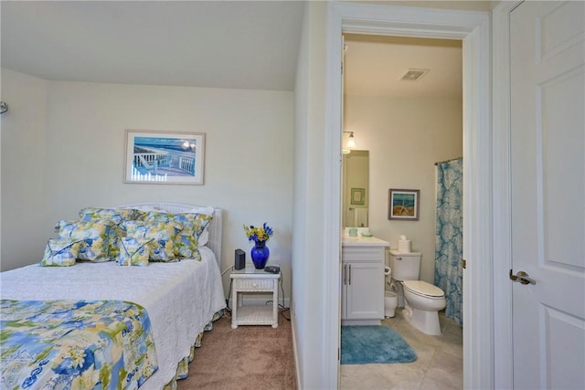 carpeted bedroom featuring connected bathroom