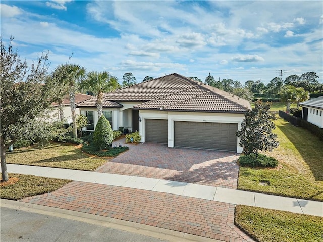 view of front of property with a garage and a front yard