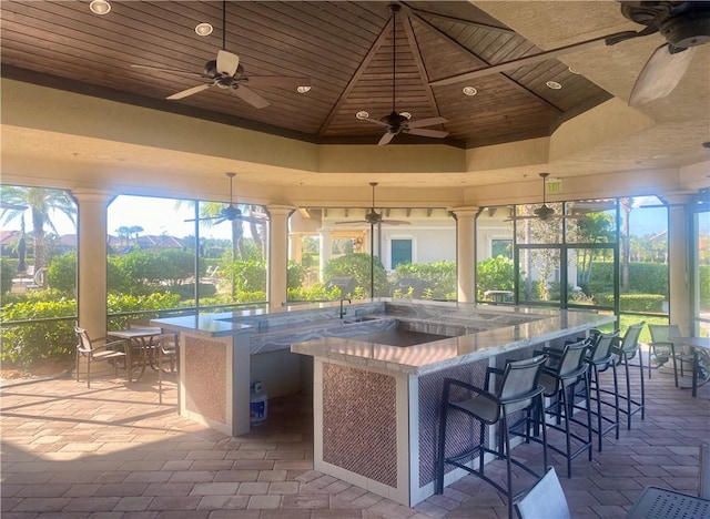 sunroom / solarium with a tray ceiling, wooden ceiling, and a jacuzzi