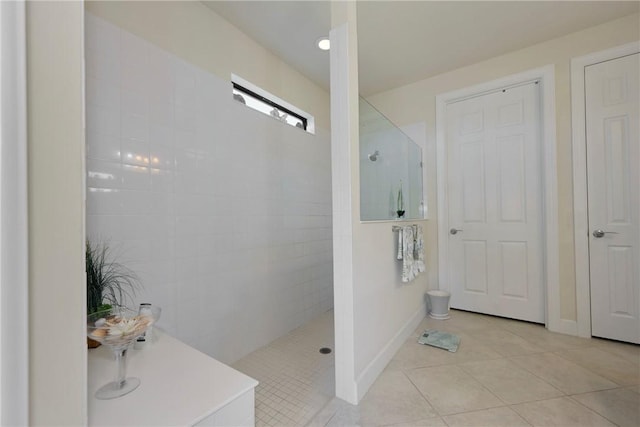 bathroom featuring a tile shower and tile patterned floors