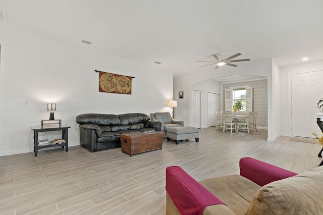 living room with light hardwood / wood-style floors and ceiling fan