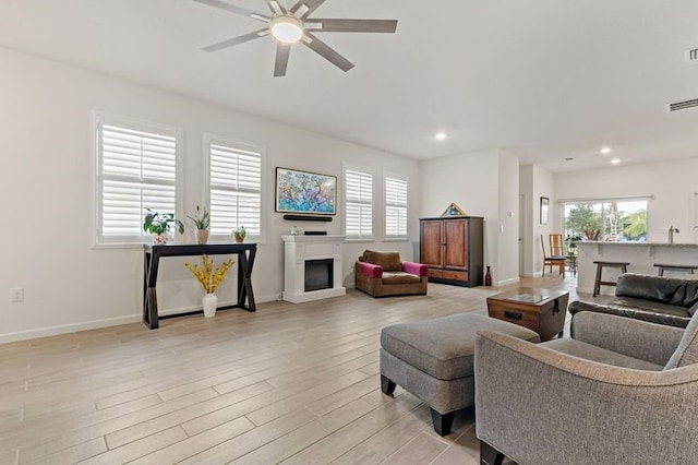 living room with light wood-type flooring and ceiling fan