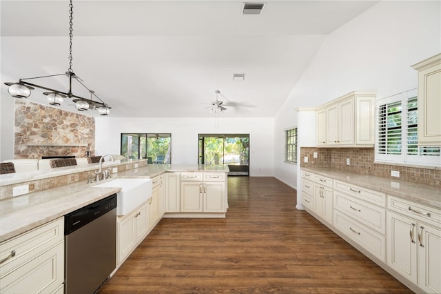 kitchen featuring sink, dark wood-type flooring, stainless steel dishwasher, cream cabinets, and decorative light fixtures