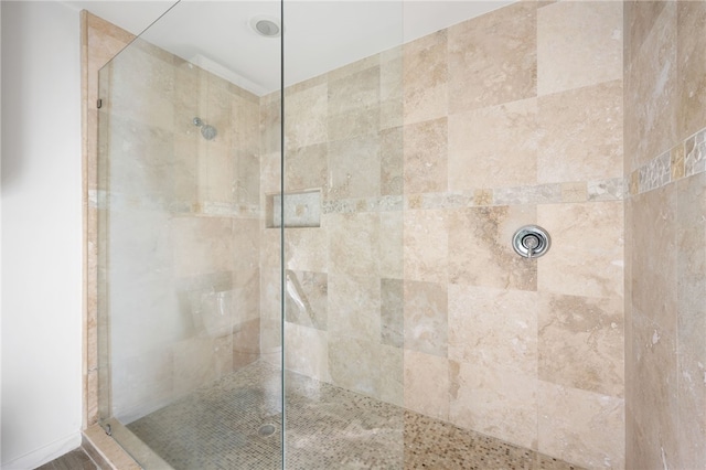 bathroom with a tile shower