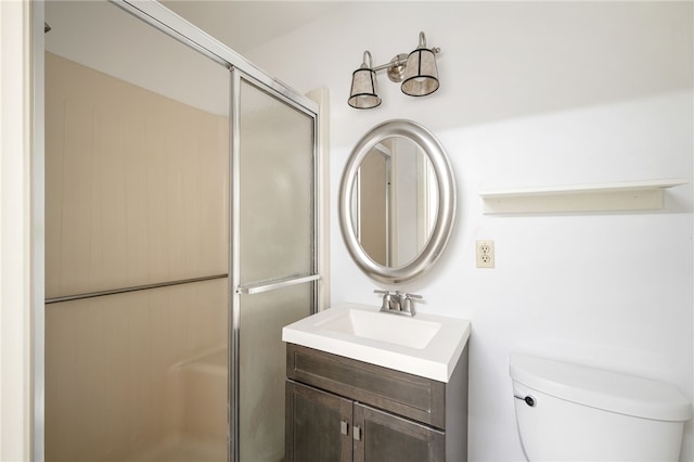 bathroom featuring vanity, toilet, and an enclosed shower