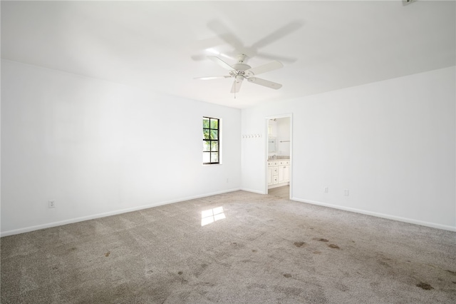 unfurnished room featuring ceiling fan and light colored carpet