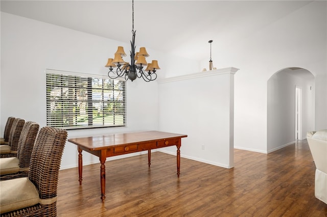 dining space featuring dark hardwood / wood-style flooring, high vaulted ceiling, and a notable chandelier