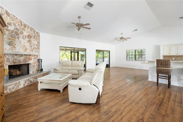 living room featuring ceiling fan, a fireplace, dark hardwood / wood-style floors, and vaulted ceiling