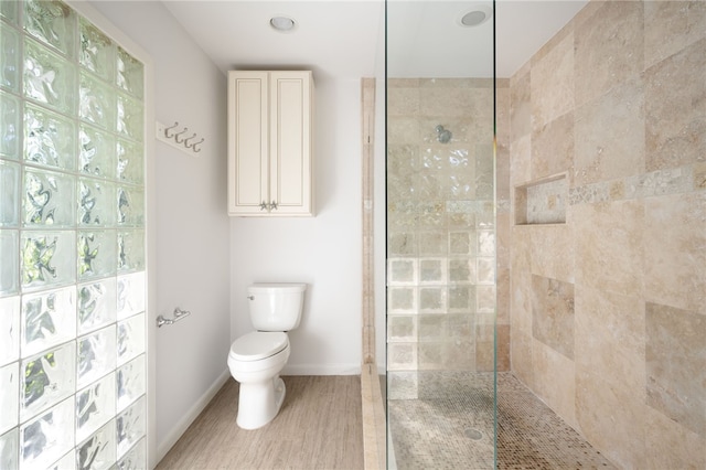 bathroom with toilet and tiled shower